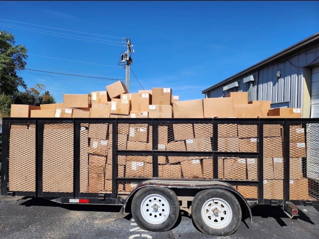 A 417 Hauling trailer stacked high with boxes after a full property cleanout